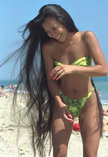 from: photobucket.com - a young lady at the beach with very long hair.