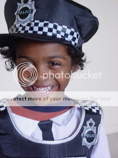 Litlle guy dressed up as a Policeman