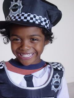 Litlle guy dressed up as a Policeman