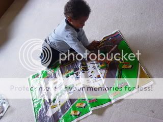 Little boy playing with car play mat