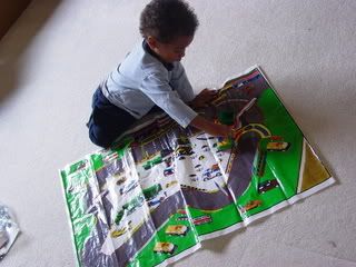 Little boy playing with car play mat